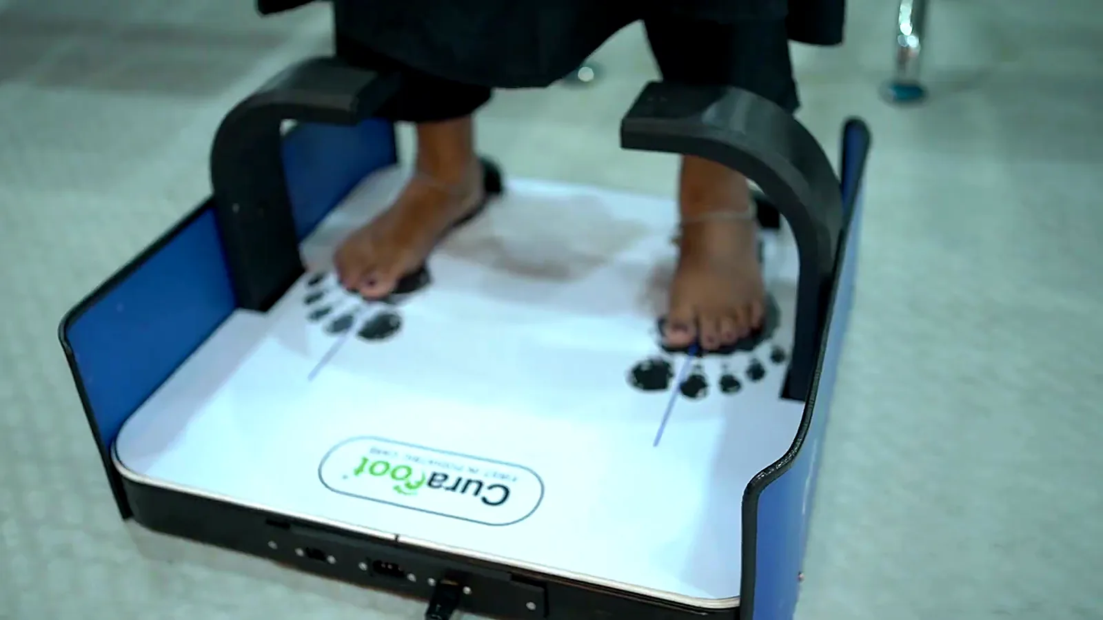 Patient's feet on the CuraFoot 3D foot scanner at the clinic