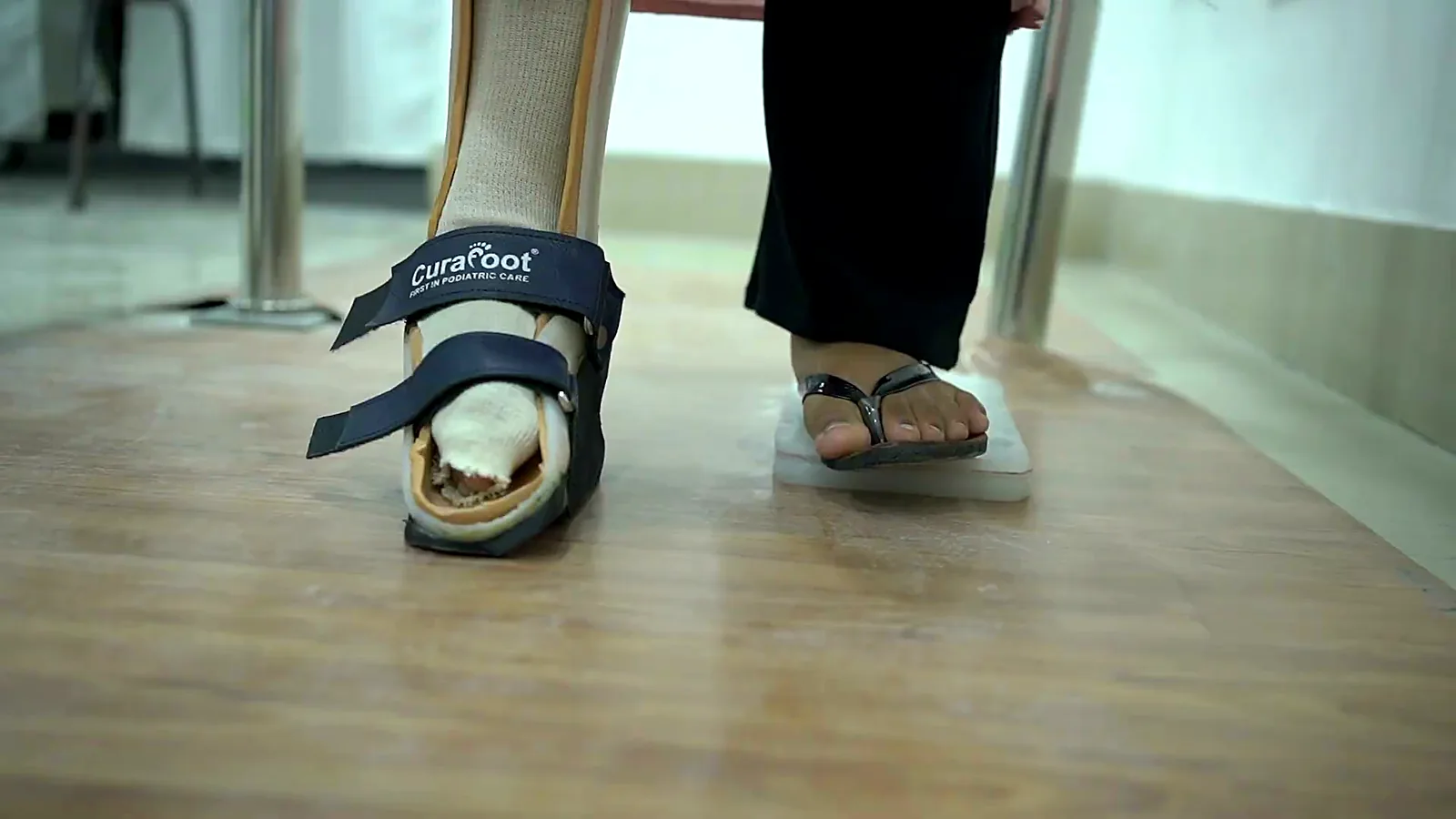 Patient walking in an ankle foot orthosis made by CuraFoot