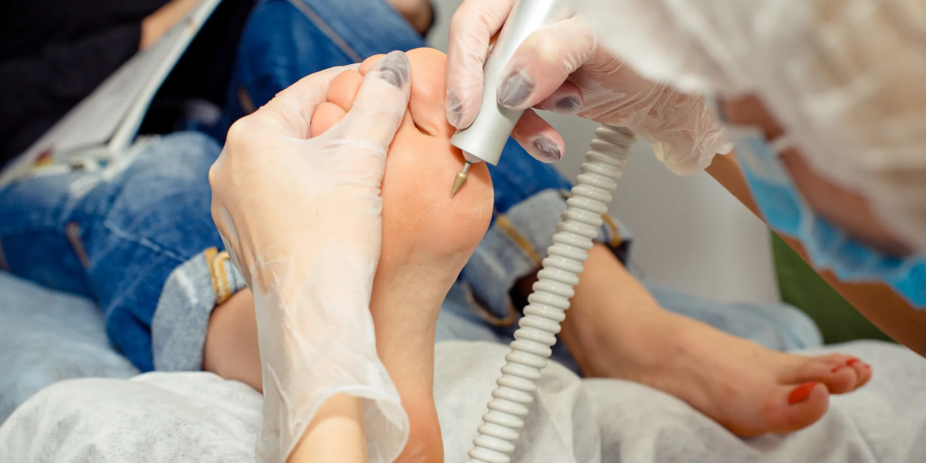 A CuraFoot clinician examining a patient's foot during an assessment